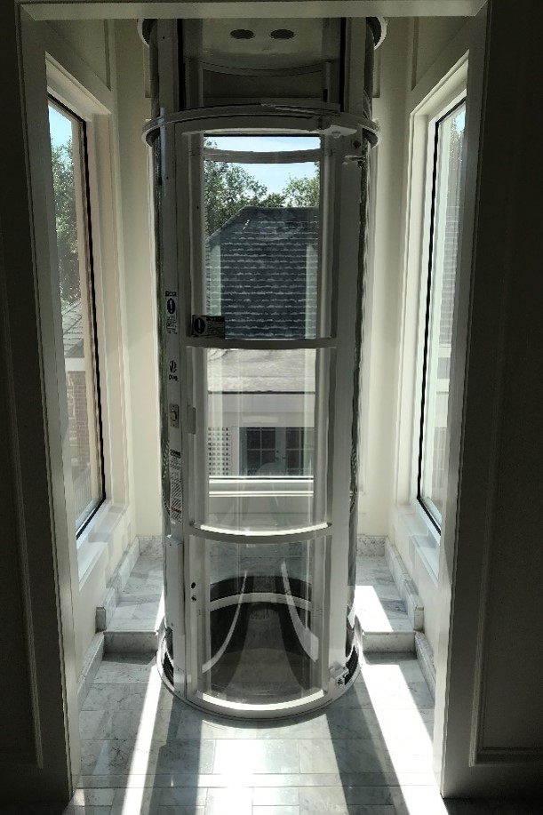 vacuum elevator installed in glass enclosed area of a front porch