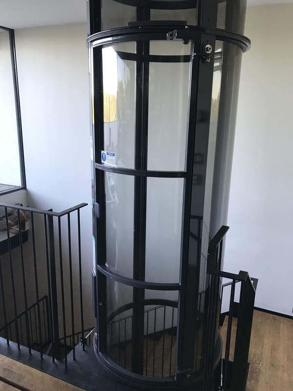 vacuum elevator installed at top of a stair landing in an austin area home